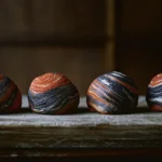 Spiral pastries with black, orange and white swirled crusts on wood