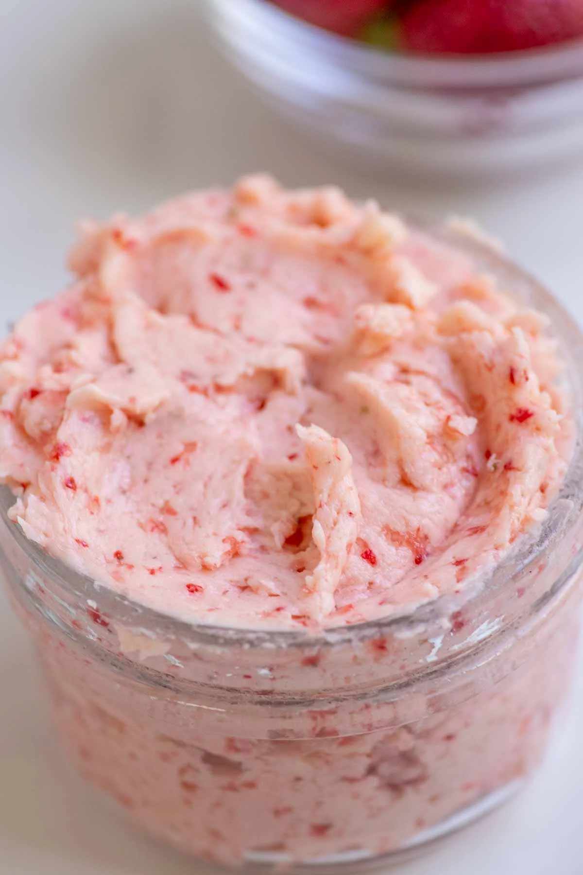 Pink whipped strawberry butter in a ceramic bowl