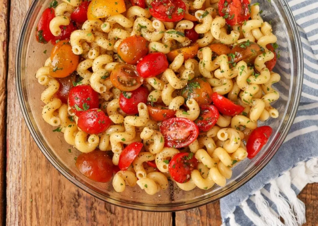 Bowl of fresh tomato pasta salad tossed with herbs
