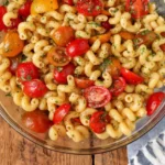 Bowl of fresh tomato pasta salad tossed with herbs