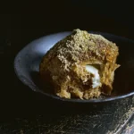 Golden Kahlua bun broken open revealing mascarpone cream filling