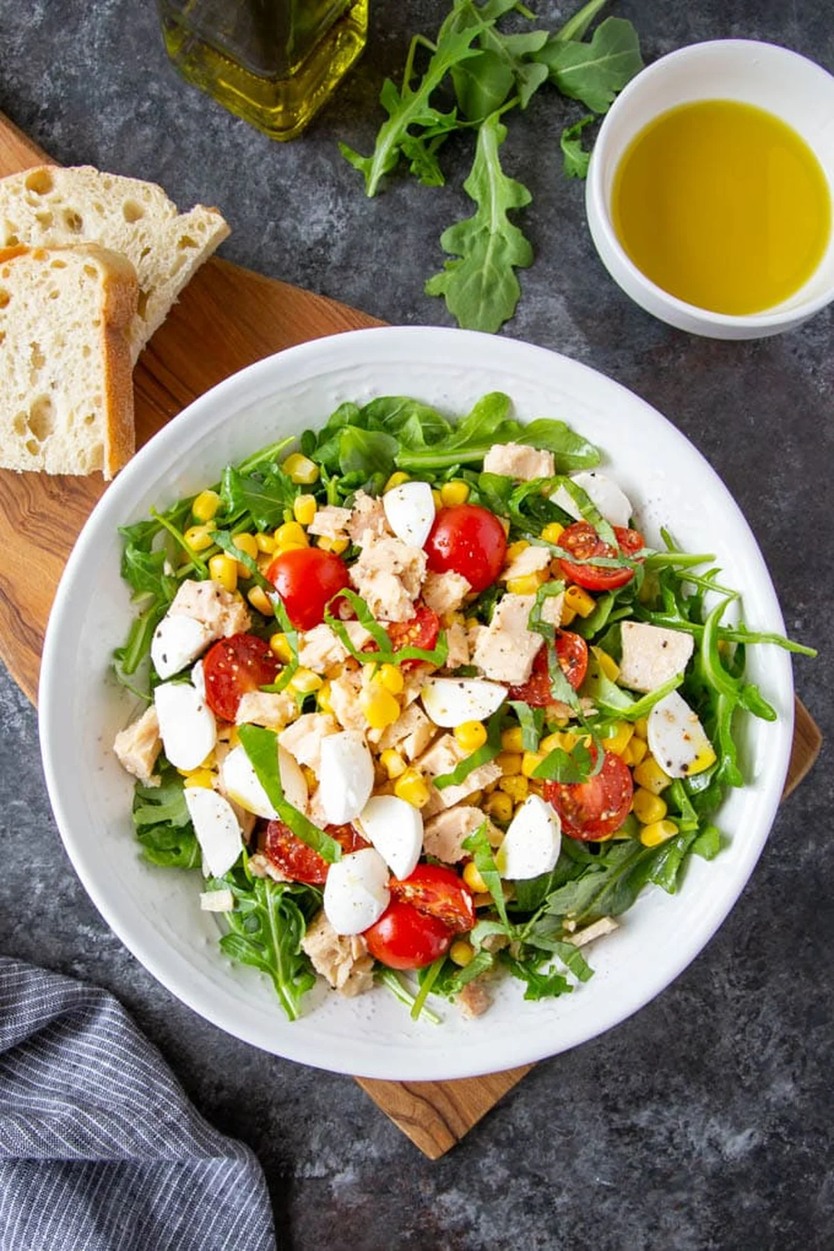 Bowl of Italian tuna salad with arugula, tomatoes and corn