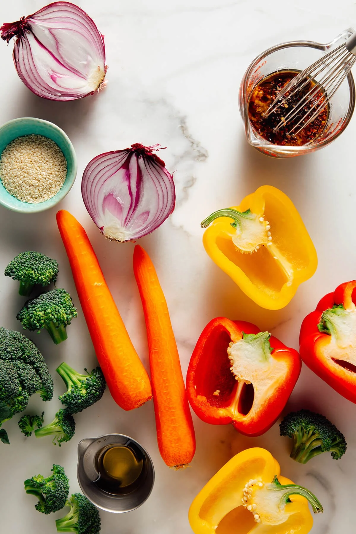 Fresh vegetables and whisked sauce arranged on marble