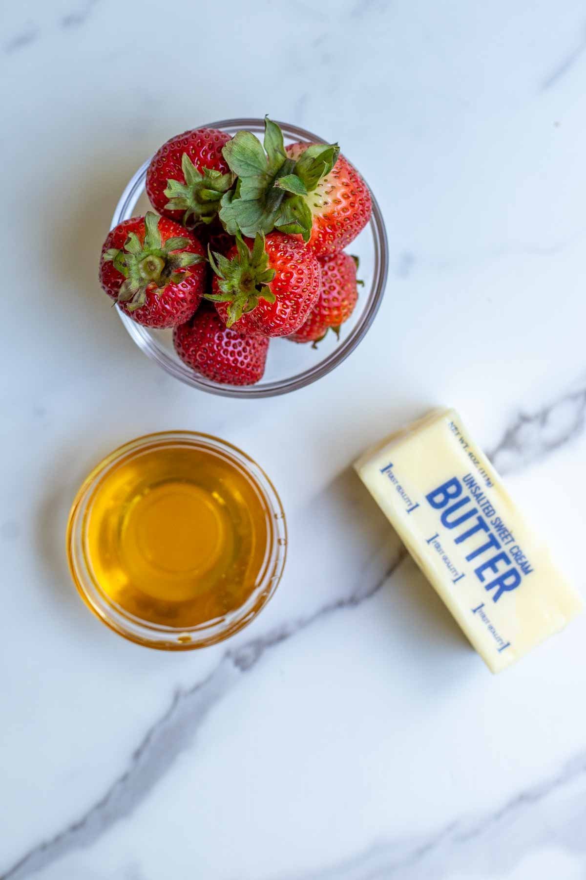 Strawberries and butter on a marble surface