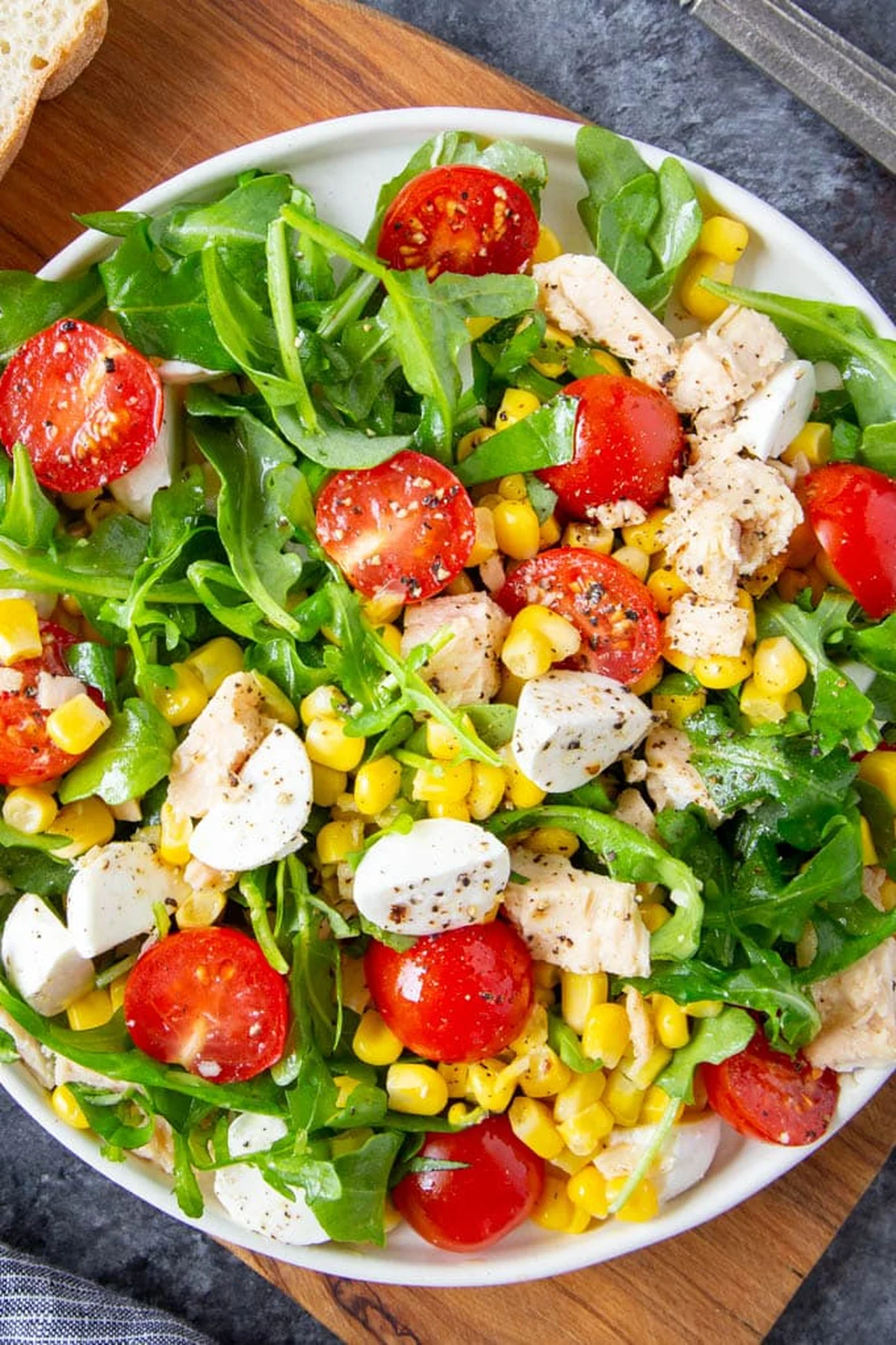 Close-up of fresh arugula being dressed with olive oil