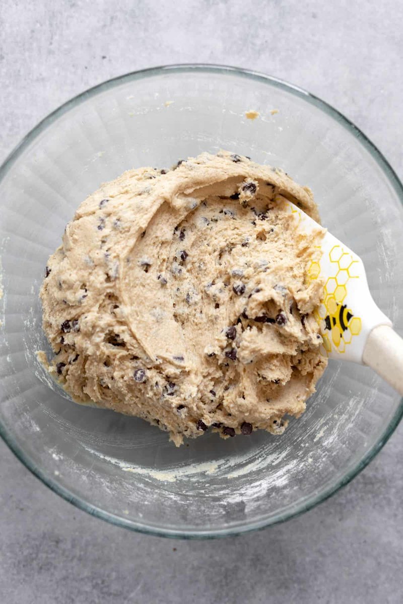 Freshly baked chocolate chip cookies cooling on the baking sheet