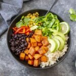 Finished sweet potato burrito bowl with avocado and cilantro