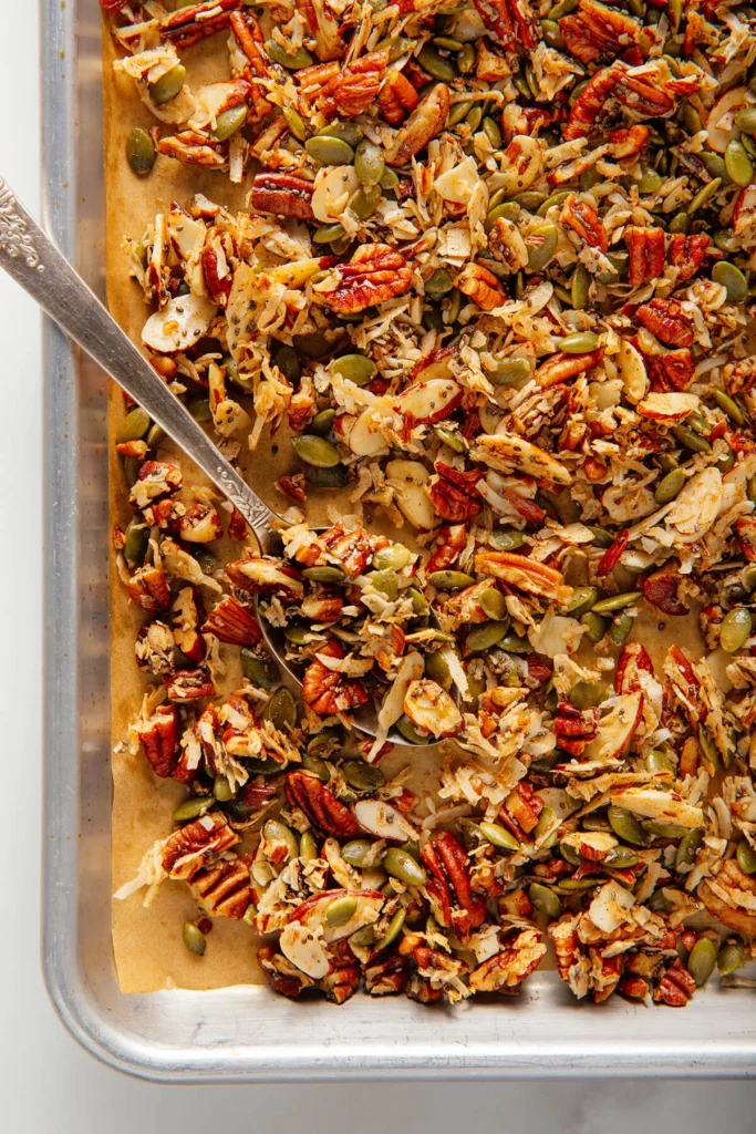 Grain-free granola sprinkled over a bowl of yogurt with berries