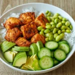Air fryer salmon bowl with rice, edamame, avocado and cucumber
