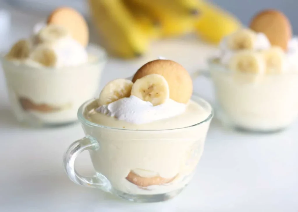 Layered Nilla wafer banana pudding cups with banana slices and cream