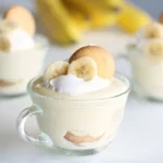 Layered Nilla wafer banana pudding cups with banana slices and cream