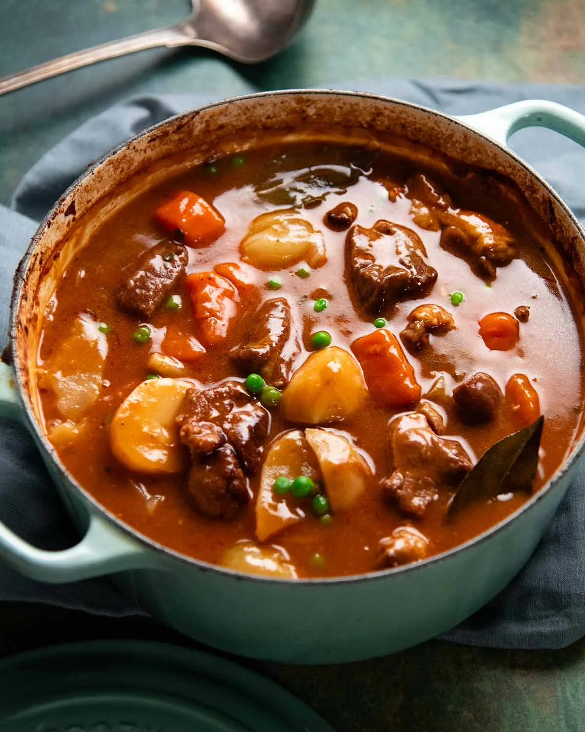 Finished lamb navarin stew in a light blue pot