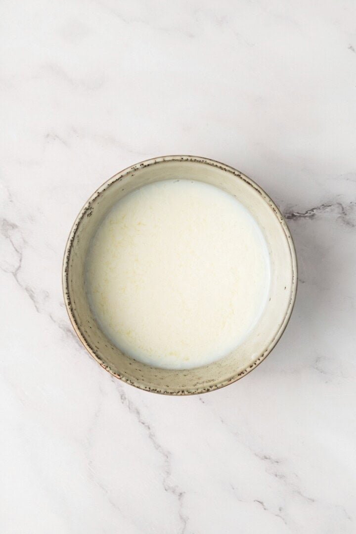 Vegan milk in a ceramic bowl, top-down view
