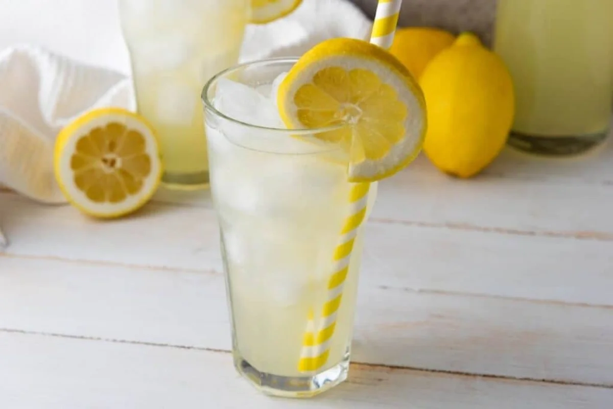 Lemons, sugar, and mint laid out as lemonade ingredients