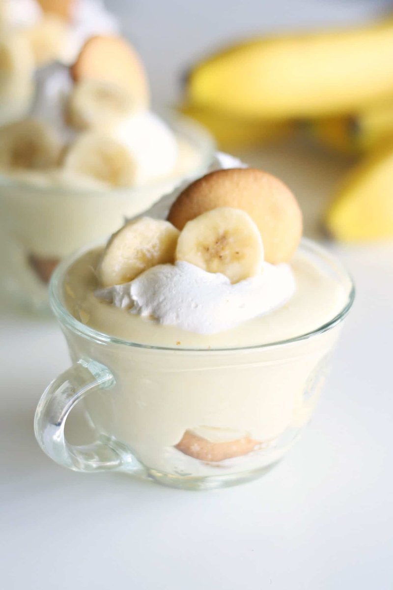 Close-up of layered banana pudding in a glass with cream topping