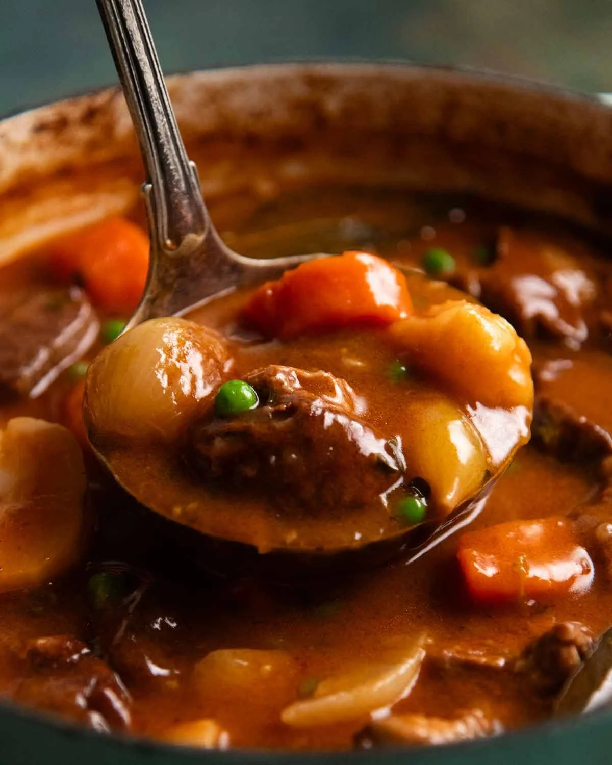 Lamb pieces browning in a heavy pot on the stove