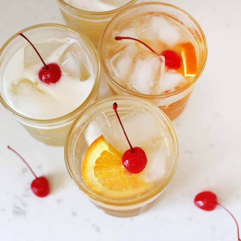 Classic amaretto sour served over ice with orange garnish