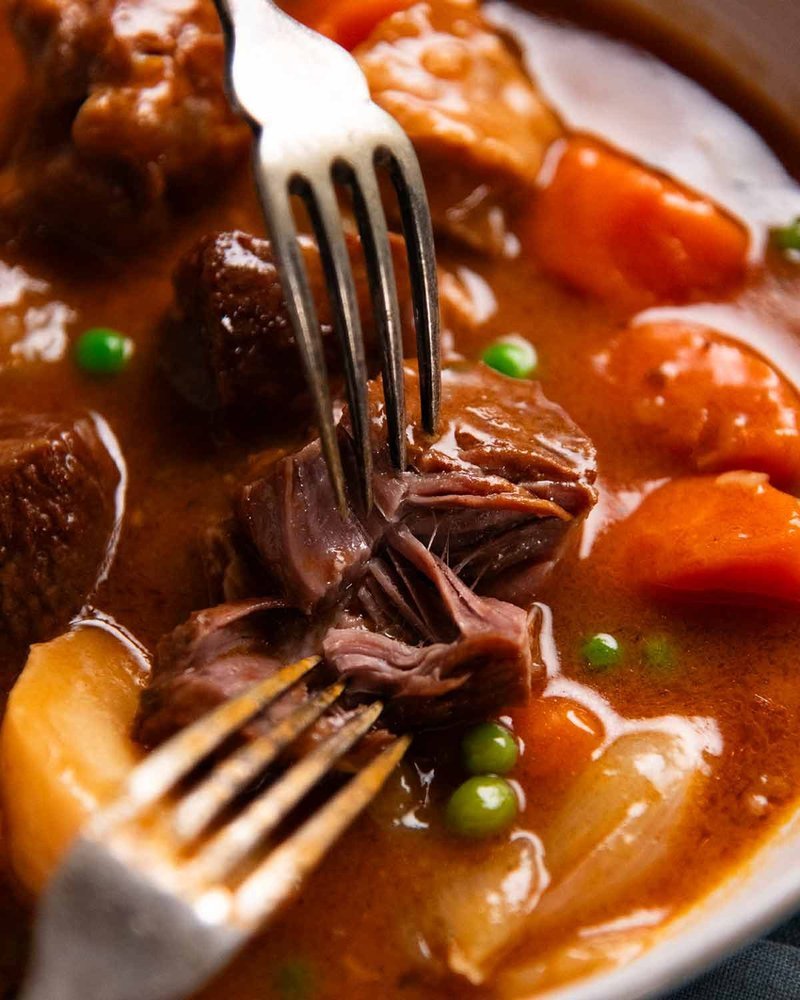 Fork pulling apart tender lamb in the stew