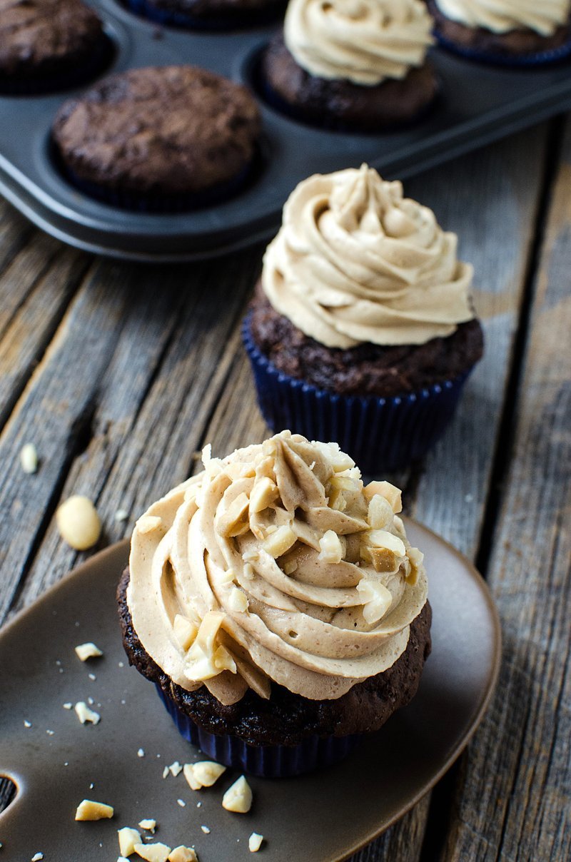 Stack of frosted chocolate zucchini cupcakes with peanut butter swirl